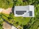 An aerial view shows a home's new roof with solar panels plus a manicured lawn at 321 Barbara Cir, Belleair, FL 33756