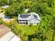Aerial view of a home boasting solar panels and a charming porch surrounded by mature landscaping at 321 Barbara Cir, Belleair, FL 33756