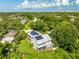 Great high aerial view of a home with large windows, greenery and solar panels at 321 Barbara Cir, Belleair, FL 33756