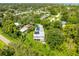 An aerial view of a residence surrounded by lush greenery and features a solar panel roof at 321 Barbara Cir, Belleair, FL 33756