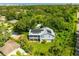 Stunning aerial view of home featuring solar panels and lush greenery in a quiet neighborhood with water views at 321 Barbara Cir, Belleair, FL 33756