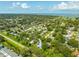 Scenic aerial view of a residential area, showcasing homes nestled among trees near the waterfront at 321 Barbara Cir, Belleair, FL 33756