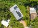 Aerial view of home's roof with solar panels and lush green backyard at 321 Barbara Cir, Belleair, FL 33756