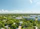 Expansive aerial view showing a residential area with lush greenery and apartment buildings at 321 Barbara Cir, Belleair, FL 33756