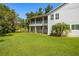 Expansive backyard view featuring a well-manicured lawn and the home's exterior at 321 Barbara Cir, Belleair, FL 33756