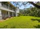 Large backyard with beautiful lawn, mature trees, and fencing, offering privacy and space for recreation at 321 Barbara Cir, Belleair, FL 33756