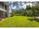 Large backyard offers privacy with a fenced area and mature trees at 321 Barbara Cir, Belleair, FL 33756