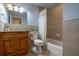 Bathroom boasts a single vanity, neutral tile, and tub-shower with neutral-colored tiles creating a clean aesthetic at 321 Barbara Cir, Belleair, FL 33756