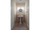 This powder room includes a pedestal sink, modern lighting, and stylish accessories at 321 Barbara Cir, Belleair, FL 33756