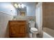 Well-lit bathroom featuring a vanity, toilet, and shower-tub combo at 321 Barbara Cir, Belleair, FL 33756