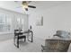 Bedroom with two large windows, a desk, a ceiling fan and two stylish chairs creating a comfortable retreat at 321 Barbara Cir, Belleair, FL 33756