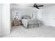 Bright and airy primary bedroom with plush carpet, ceiling fan and serene ambiance at 321 Barbara Cir, Belleair, FL 33756