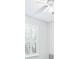 White bedroom with a window with shutter blinds and ceiling fan at 321 Barbara Cir, Belleair, FL 33756