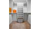 Walk-in closet features built-in shelving with hanging rods and a laundry basket for maximum storage and organization at 321 Barbara Cir, Belleair, FL 33756