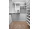 Spacious walk-in closet featuring custom shelving and rods that provide efficient storage solutions with carpet flooring at 321 Barbara Cir, Belleair, FL 33756