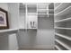 Organized walk-in closet with adjustable shelving for optimal storage and a designer shopping bag at 321 Barbara Cir, Belleair, FL 33756