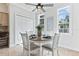 Bright dining area with natural light and modern ceiling fan fixture at 321 Barbara Cir, Belleair, FL 33756