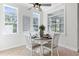Sunlit dining area features bright windows and a ceiling fan fixture at 321 Barbara Cir, Belleair, FL 33756