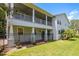 Charming exterior of a two-story home with a screened-in porch and black metal fence at 321 Barbara Cir, Belleair, FL 33756