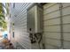 Tankless water heater mounted on the exterior wall of the house with visible plumbing connections at 321 Barbara Cir, Belleair, FL 33756