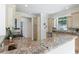 Bright kitchen with granite countertops, stainless steel appliances, and ample storage at 321 Barbara Cir, Belleair, FL 33756