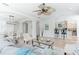 Spacious living room with tile floors, ceiling fan, open archways and comfortable seating near dining and kitchen at 321 Barbara Cir, Belleair, FL 33756