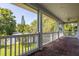 Brick floored covered porch with white railings at 321 Barbara Cir, Belleair, FL 33756