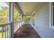 Covered porch with brick flooring, columns and ceiling fan at 321 Barbara Cir, Belleair, FL 33756