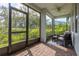 Comfortable screened porch featuring brick flooring and peaceful garden views at 321 Barbara Cir, Belleair, FL 33756