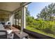 Relaxing screened porch with comfortable seating and views of the landscaped backyard at 321 Barbara Cir, Belleair, FL 33756