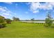 Beautiful backyard with manicured lawn and picturesque view of the serene lake and clear blue sky at 3214 Forsythia Dr, Odessa, FL 33556