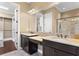 Bathroom with dual sinks, granite countertops, and walk-in closet at 3214 Forsythia Dr, Odessa, FL 33556