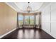Dining room features stylish lighting, a neutral color palette, hardwood floors, and backyard views at 3214 Forsythia Dr, Odessa, FL 33556