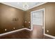 Dining room showcasing sleek hardwood floors, contemporary lighting, and a connecting doorway to another room at 3214 Forsythia Dr, Odessa, FL 33556