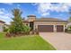 Beautiful home featuring manicured landscaping, a brick paver driveway, a tile roof, and a welcoming entrance at 3214 Forsythia Dr, Odessa, FL 33556