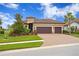 Inviting home with a three-car garage, a brick paver driveway, well-maintained landscaping, and a classic design at 3214 Forsythia Dr, Odessa, FL 33556