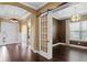Entryway with wood floors, leading to the house with a view of a dining room, and study with dark walls at 3214 Forsythia Dr, Odessa, FL 33556
