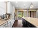 Gourmet kitchen features stone countertops and a black island with stainless steel appliances and backyard views at 3214 Forsythia Dr, Odessa, FL 33556