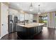 Spacious kitchen offers a large island, stainless steel appliances, hardwood floors, and outdoor views at 3214 Forsythia Dr, Odessa, FL 33556