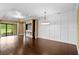 Open living space featuring a modern fireplace, dark hardwood floors, and sliding glass door to the yard at 3214 Forsythia Dr, Odessa, FL 33556