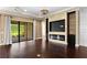 Stylish living room featuring a modern fireplace, built-in shelving, and sliding glass doors to the patio at 3214 Forsythia Dr, Odessa, FL 33556