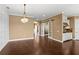 Open-concept living space with hardwood floors, and a modern kitchen in the background at 3214 Forsythia Dr, Odessa, FL 33556