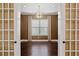 This office features hardwood floors, custom light fixture, and light-blocking curtains at 3214 Forsythia Dr, Odessa, FL 33556