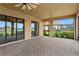 Beautiful patio with a brick floor and screened windows overlooking the manicured backyard and lake at 3214 Forsythia Dr, Odessa, FL 33556