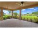 A screened-in patio offering stunning views of the lake and landscaping, complete with stone flooring at 3214 Forsythia Dr, Odessa, FL 33556