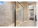 Walk-in shower with glass enclosure, tile surround, and high-end fixtures at 3214 Forsythia Dr, Odessa, FL 33556