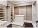 Spacious walk-in closet with custom shelving and storage solutions, including an island for added convenience at 3214 Forsythia Dr, Odessa, FL 33556