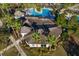 Aerial view of community pool showcasing its unique shape and surrounding landscaping at 33854 Floating Heart Ct, Wesley Chapel, FL 33545