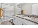 Bathroom featuring a double sink granite countertop, modern fixtures, and a shower-tub combo at 33854 Floating Heart Ct, Wesley Chapel, FL 33545