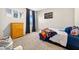 Cozy bedroom with a single bed, dresser, and abstract wall art and window with lots of light at 33854 Floating Heart Ct, Wesley Chapel, FL 33545